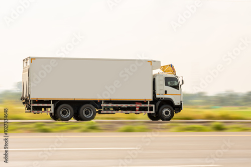 Side view of a small truck driving on a country road, truck running on the road, small truck on the road.