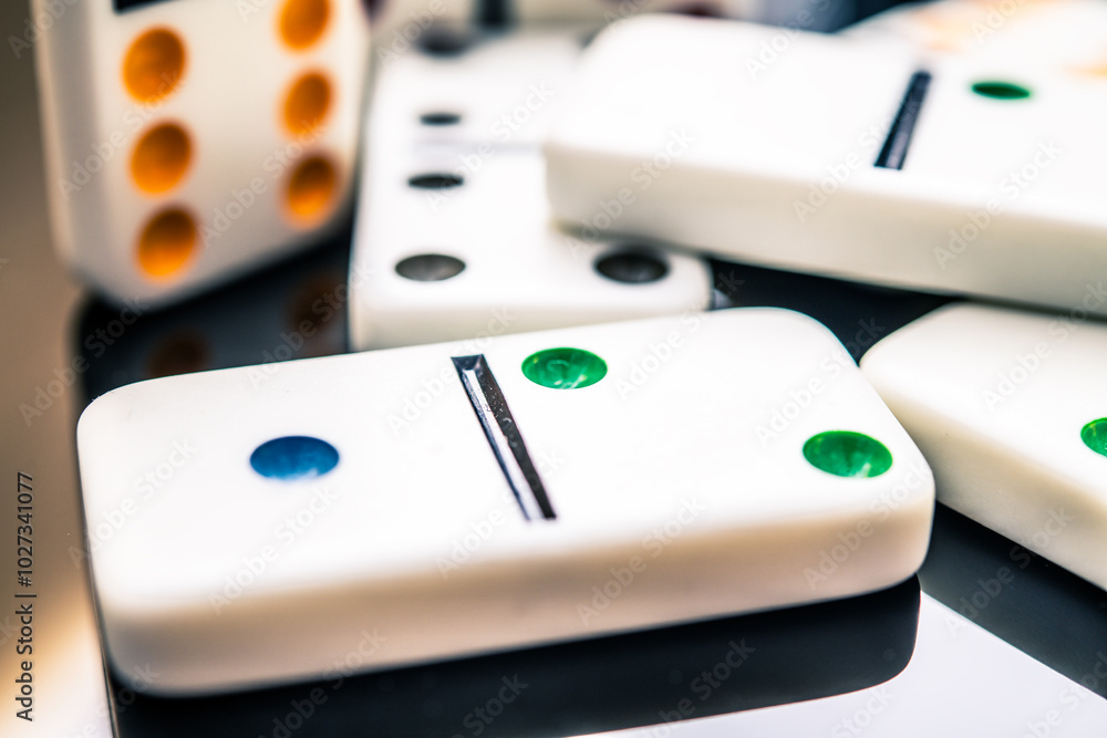 Colorful Dominoes on Glossy Surface - A Close-Up View of Classic Game Pieces, Capturing Strategy, Fun and Social Interaction while Playing with Friends or Family