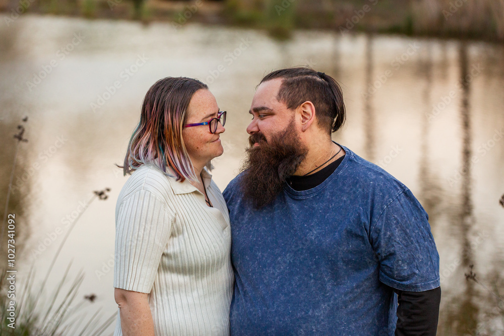 Aboriginal australian couple standing together by waterside at dusk Aboriginal australian couple standing together by waterside at dusk