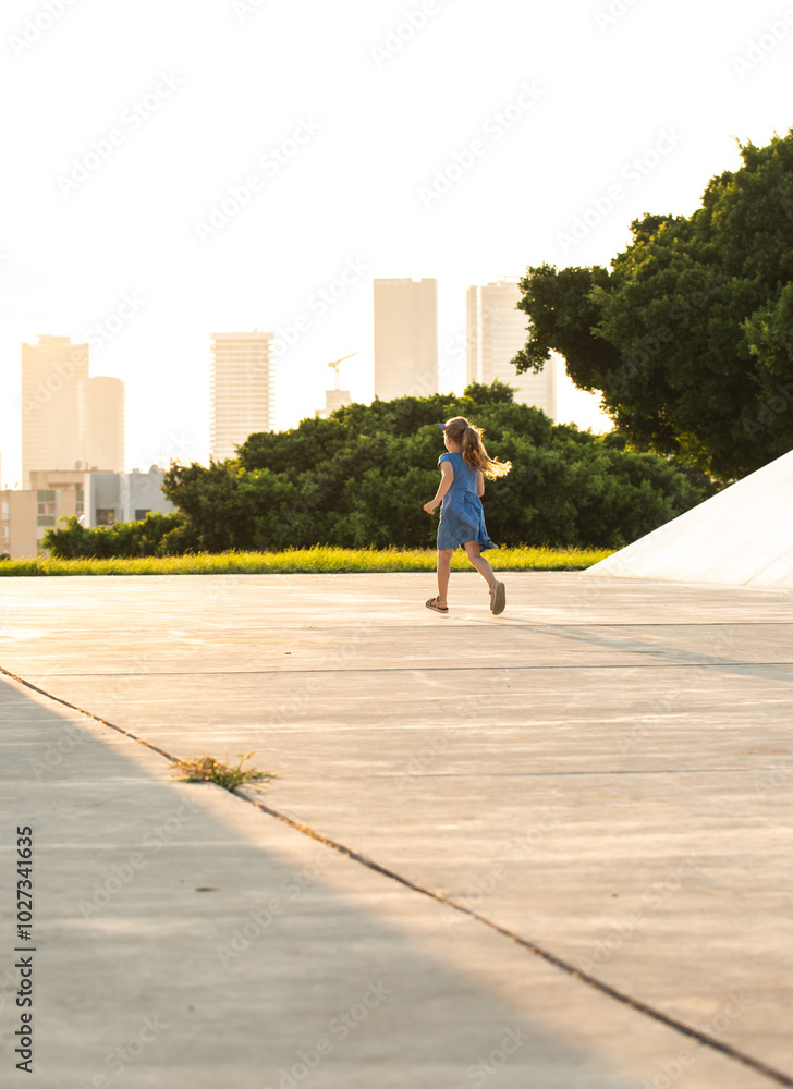 Little girl running and playing in a park