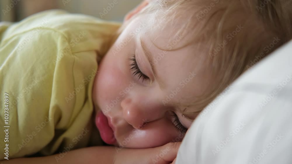 Peaceful adorable baby sleeping on a bed at home. Slumbering little child. Two years old girl sleeps peaceful at domestic room interior background. Serene dream. Cute face close up. Deep kid slumber Peaceful adorable baby sleeping on a bed at home. Slumbering little child. Two years old girl sleeps peaceful at domestic room interior background. Serene dream. Cute face close up. Deep kid slumber