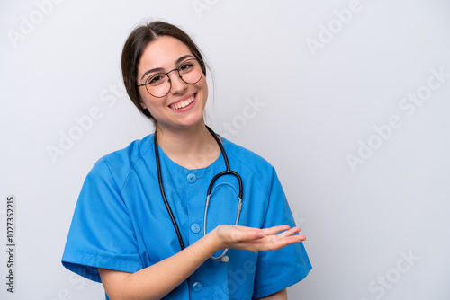 surgeon doctor woman holding tools isolated on white background presenting an idea while looking smiling towards