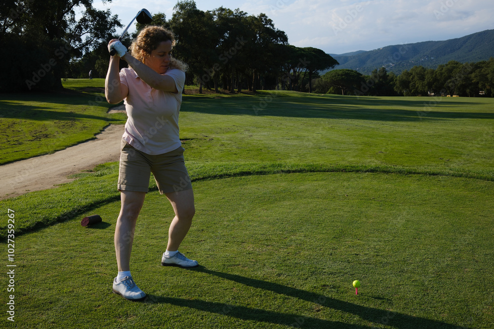 woman playing golf on the green fairway course woman playing golf on the green fairway course