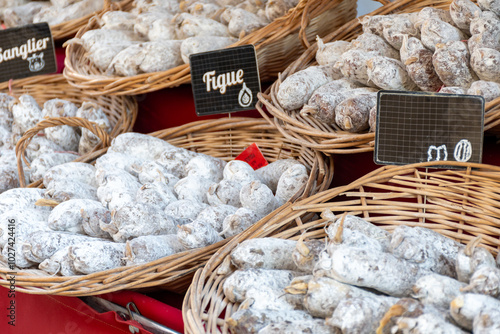 Variety of homemade dried salami sausages in French butchery shop, Dordogne, France, meat food background close up photo