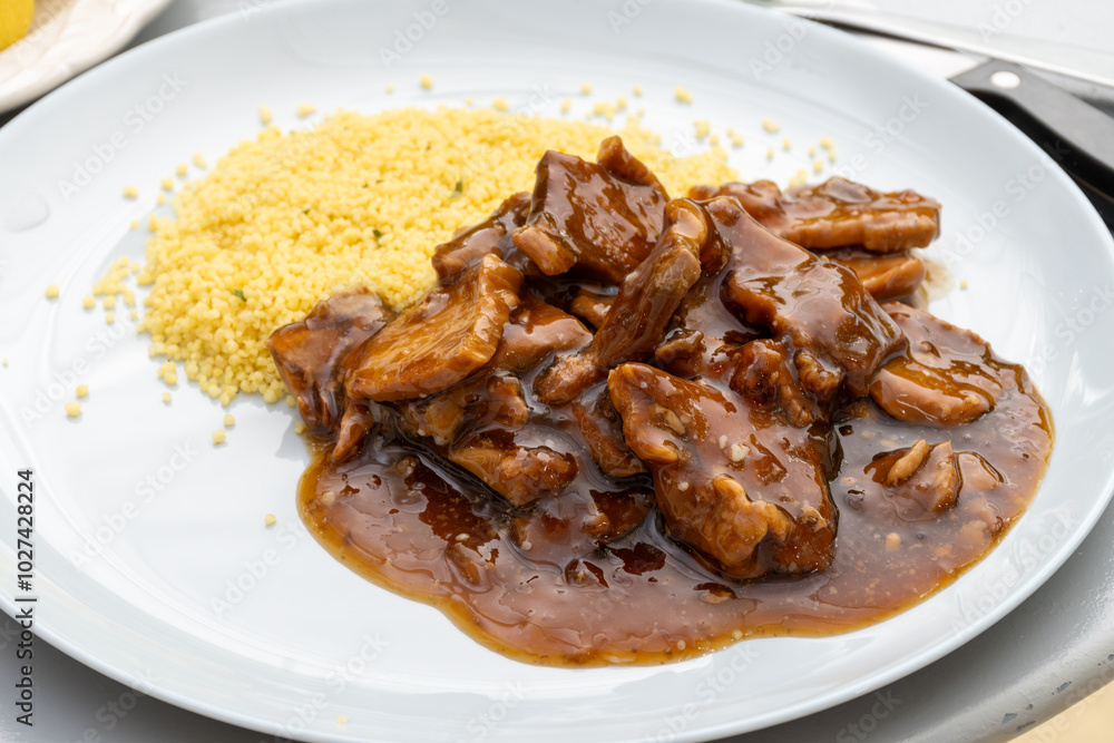 Meat dish Caramel pork served with couscous Meat dish Caramel pork served with couscous