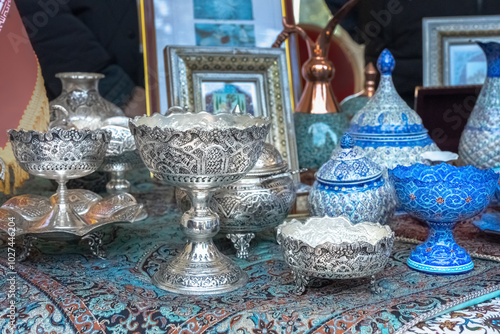 Silver and ceramic ware in traditional oriental style sold at a street market