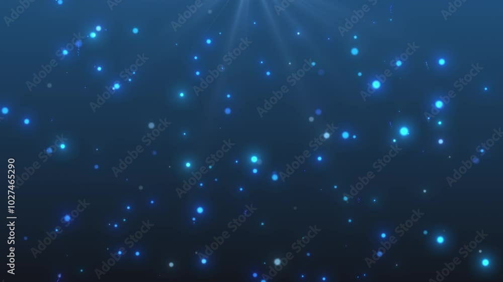 Multi-colored glowing blue particles on a blue background with a ray of light at the top Multi-colored glowing blue particles on a blue background with a ray of light at the top