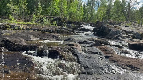 River runs over rocks in a forest