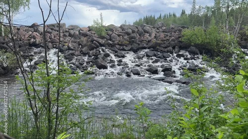 Water leaking through a dam made from rocks