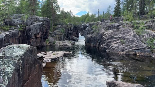 River runs over rocks in a forest