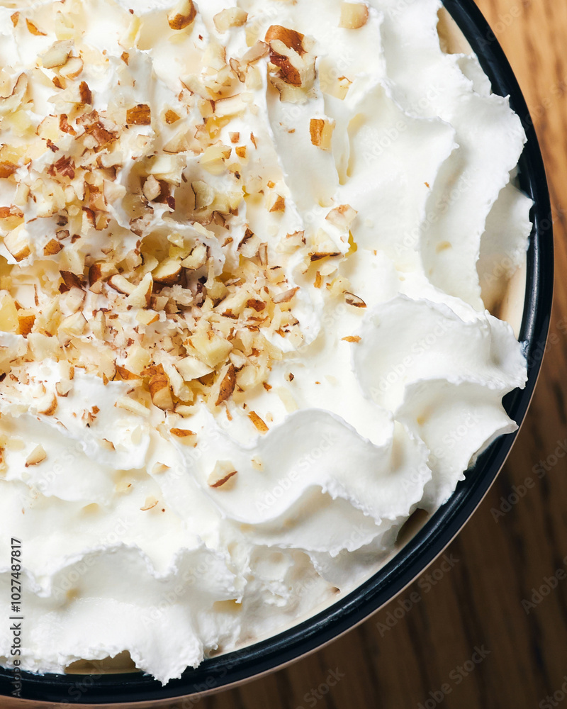 whipped cream on coffee close up. pecan sprinkles whipped cream on coffee close up. pecan sprinkles