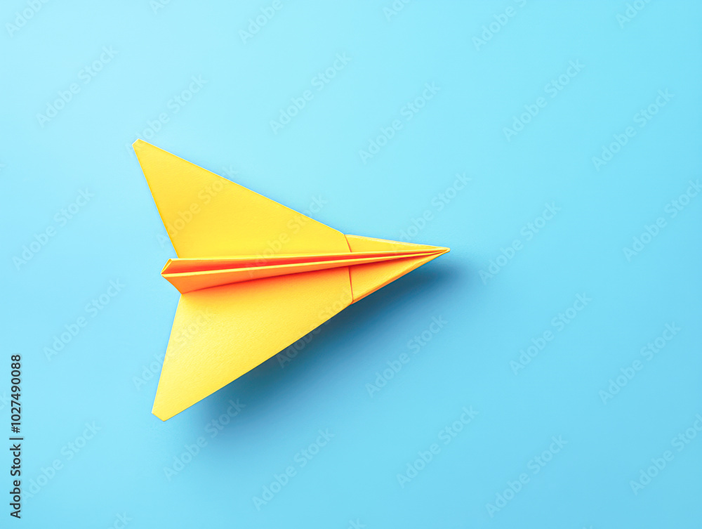 A yellow paper airplane is flying in the air A yellow paper airplane is flying in the air