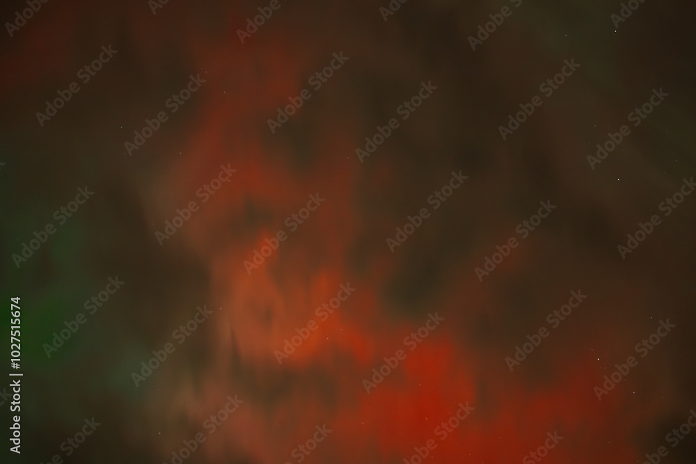 A captivating scene of the Aurora Borealis with vibrant red and orange hues illuminating the night sky. Dark clouds add drama, while subtle green light emerges through the atmosphere A captivating scene of the Aurora Borealis with vibrant red and orange hues illuminating the night sky. Dark clouds add drama, while subtle green light emerges through the atmosphere