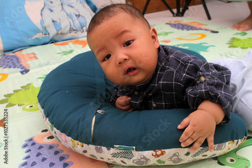 adorable asian baby boy practicing crawling
