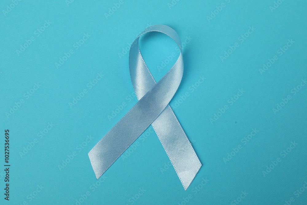 Light blue ribbon on color background, top view. Prostate cancer awareness Light blue ribbon on color background, top view. Prostate cancer awareness
