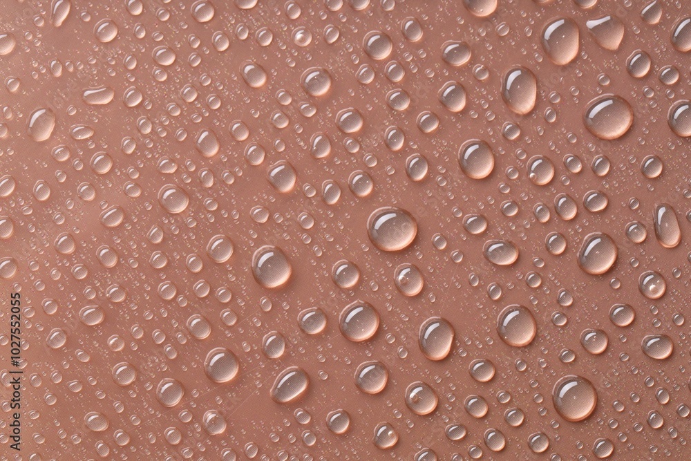 Water drops on brown background, top view Water drops on brown background, top view