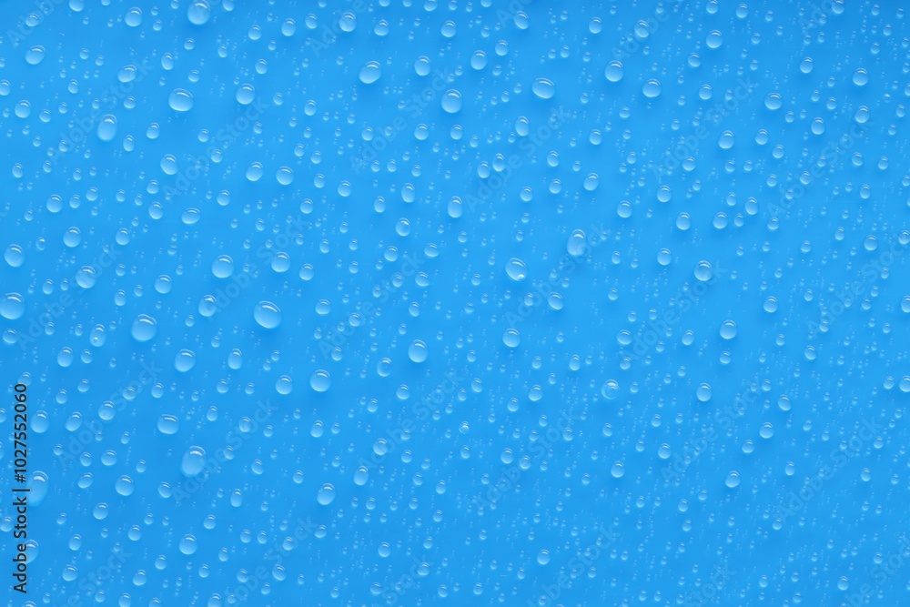 Water drops on blue background, top view Water drops on blue background, top view