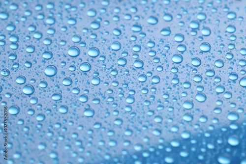 Water drops on blue background, closeup view