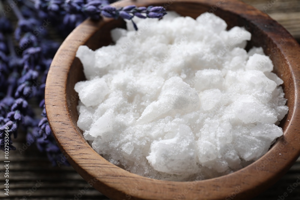 Natural sea salt in bowl and lavender on table, closeup Natural sea salt in bowl and lavender on table, closeup