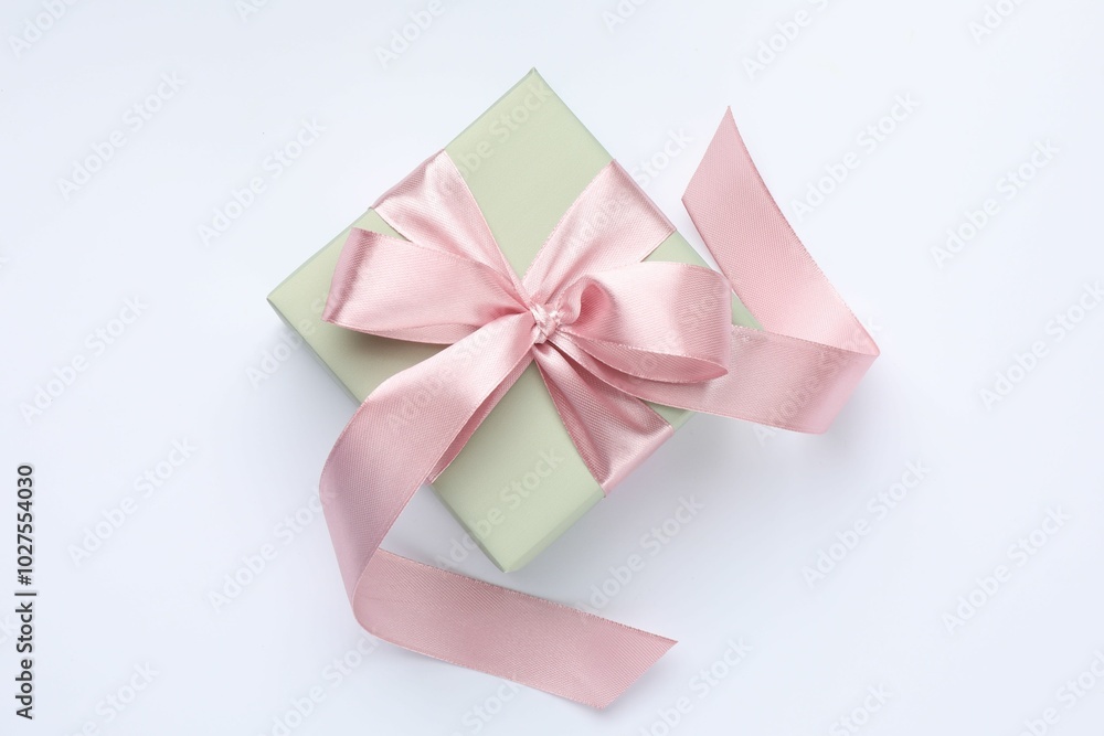 Beautiful gift box with pink bow isolated on white, top view Beautiful gift box with pink bow isolated on white, top view