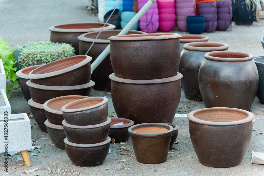 Stacked ceramic and clay pots in a pottery shop showcase a variety of terracotta planters and decorative garden containers. These eco-friendly pots add rustic charm to any garden or backyard decor. Stacked ceramic and clay pots in a pottery shop showcase a variety of terracotta planters and decorative garden containers. These eco-friendly pots add rustic charm to any garden or backyard decor.