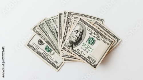 Spread out 100-dollar bills, fanned out on a clean white background, capturing the intricate details of the currency.