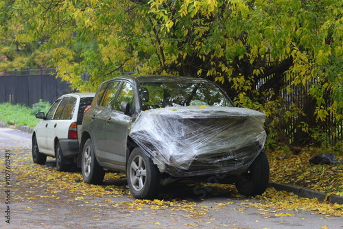 A black wrecked car after an accident is covered with plastic wrap, Narodnaya Street, Saint Petersburg, Russia, October 13, 2024