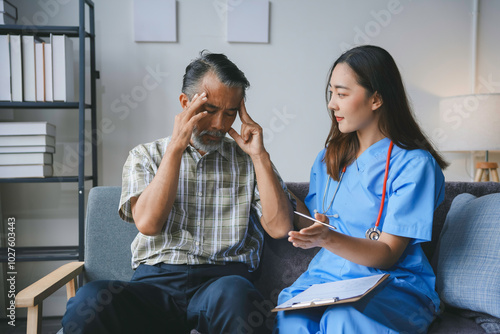 Concerned nurse is explaining a diagnosis while holding a clipboard to a senior man experiencing a headache