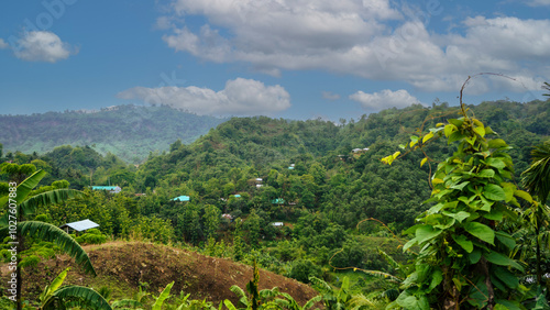 A wonderful view is full of houses and trees on the hill. Landscape of Bandarban hills. A mountain village under a blue horizon on a large canvas from a mountain top. photo