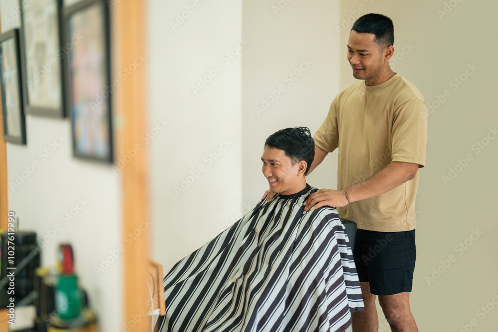 A man is currently having his hair expertly cut by a skilled barber inside a busy and lively barbershop filled with activity A man is currently having his hair expertly cut by a skilled barber inside a busy and lively barbershop filled with activity