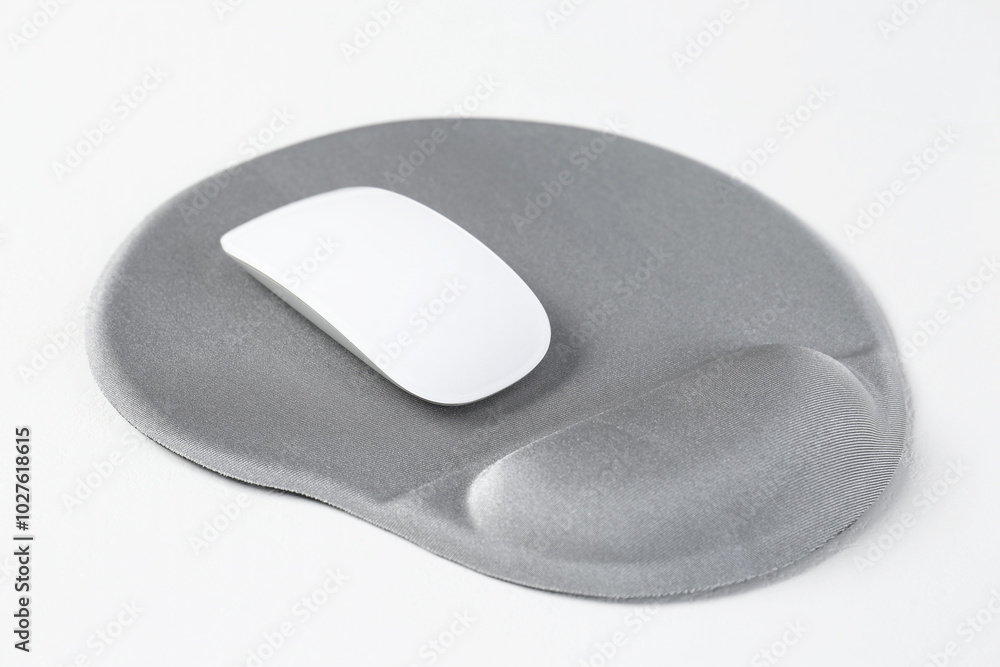 Mouse and mousepad with arm rest on white table, closeup Mouse and mousepad with arm rest on white table, closeup