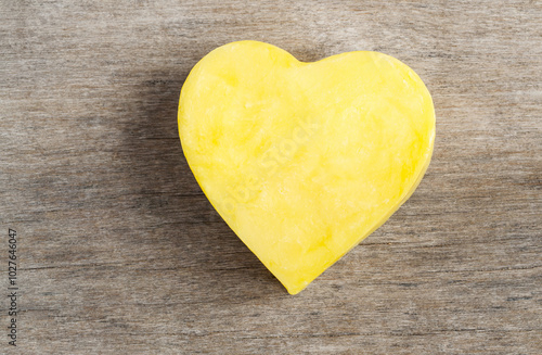 yellow heart shape on wood background