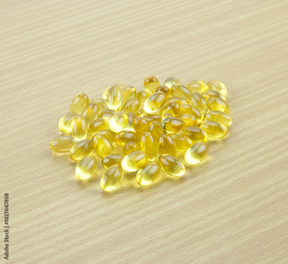 fish oil capsule on wooden background fish oil capsule on wooden background