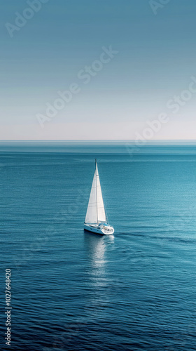 Sailboat sailing alone on calm blue ocean