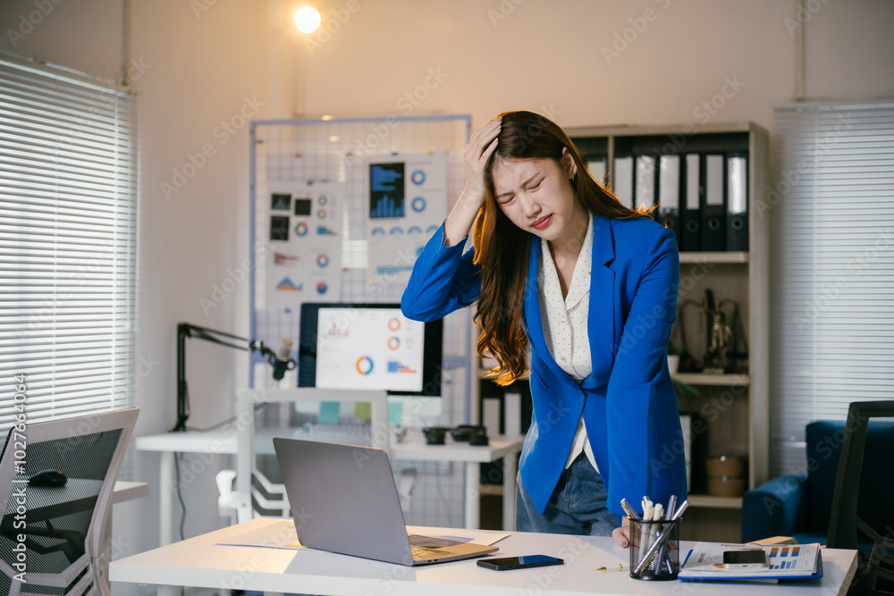 Young manager woman having a headache and feeling tired from overwork,she is stressed and has office syndrome from work Young manager woman having a headache and feeling tired from overwork,she is stressed and has office syndrome from work