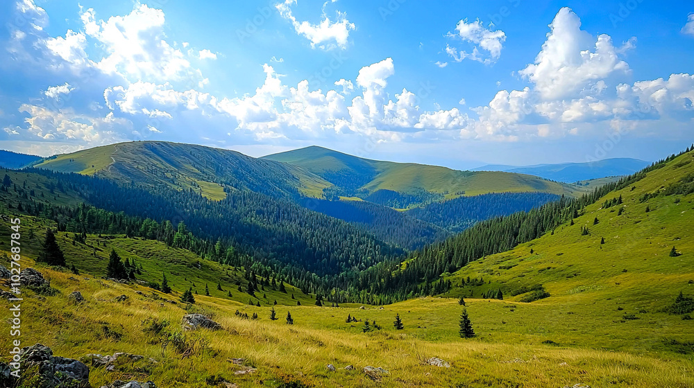 Fototapeta premium Scenic valley landscape with rolling hills and clouds.
