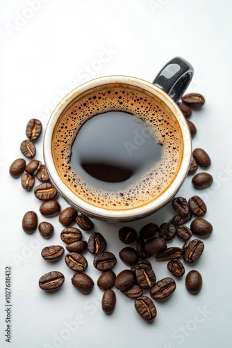 Freshly brewed coffee in a black mug surrounded by aromatic coffee beans on a...