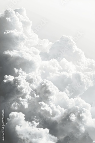 A fluffy white cloud floats peacefully in a clear blue sky during a sunny aft...
