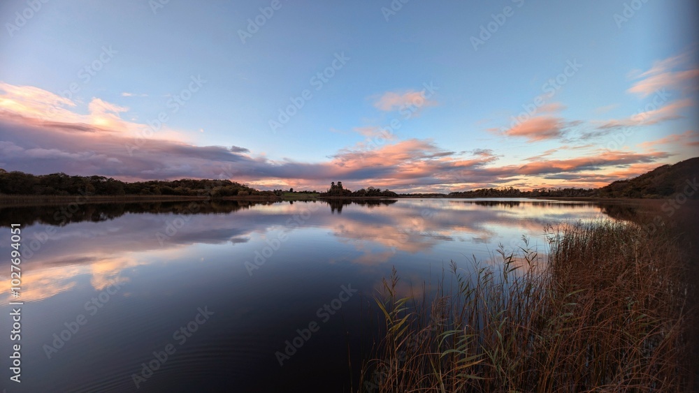 Beautiful orange sunset lakeside landscape scenery at Ross lake, Roscahill, Galway, Ireland, nature background