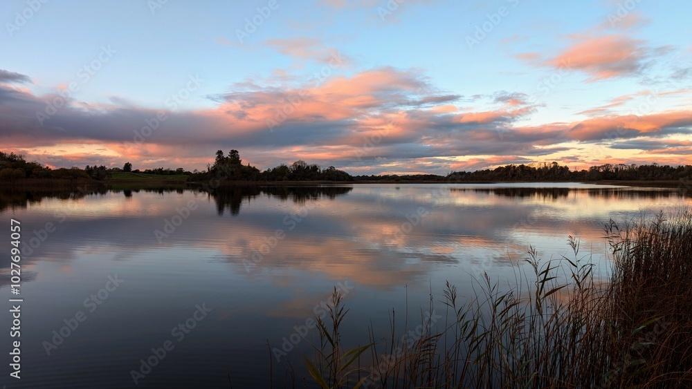 Beautiful orange sunset lakeside landscape scenery at Ross lake, Roscahill, Galway, Ireland, nature background