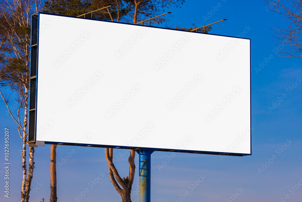 white billboard along the highway on a winter snow day. Background for design and advertising. white billboard along the highway on a winter snow day. Background for design and advertising.