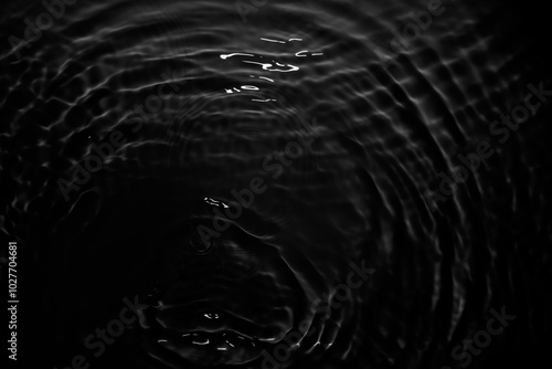 Image of black water surface with waves.