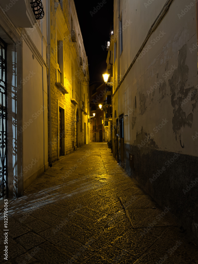 Obraz premium Elevation of buildings in the old city center. Narrow street with tenement houses in the old city. Bari, Italy.