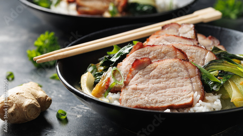 Chinese BBQ Pork Char Siu with rice and bok choy in a black bowl photo