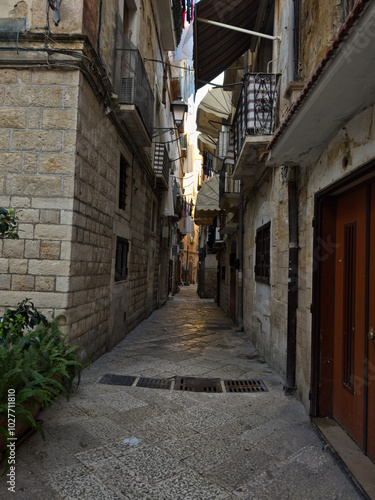 Elevation of buildings in the old city center. Narrow street with tenement houses in the old city. Bari, Italy.