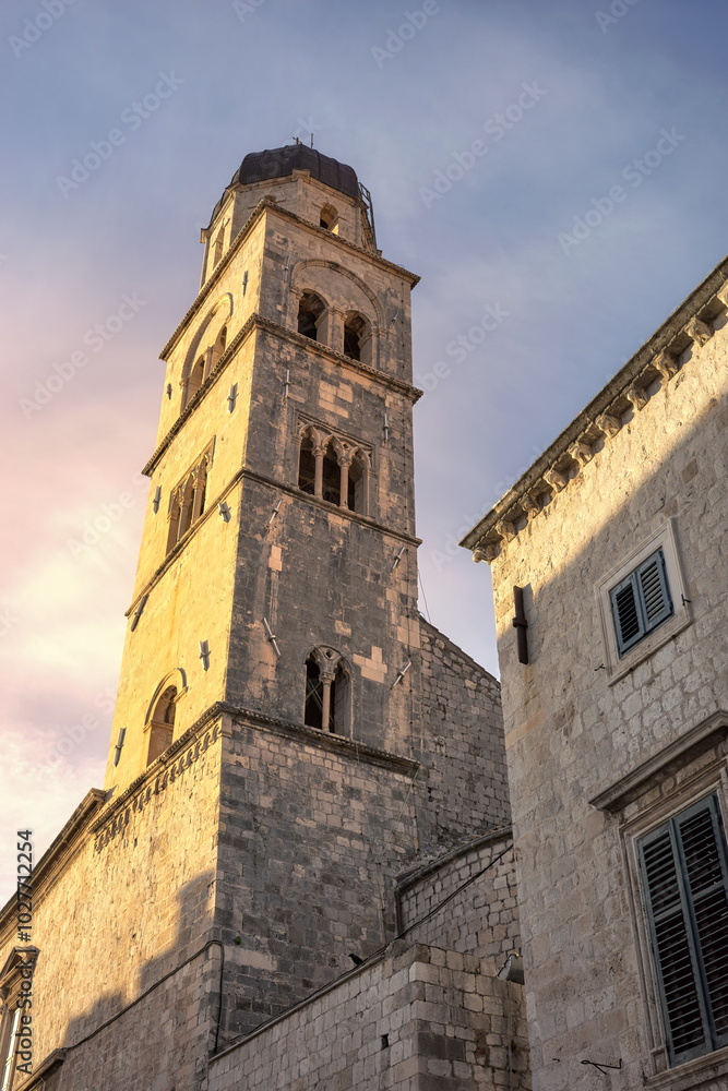 Franciscan Church tower in the old town of Dubrovnik at sunset, Croatia. Franciscan Church tower in the old town of Dubrovnik at sunset, Croatia.