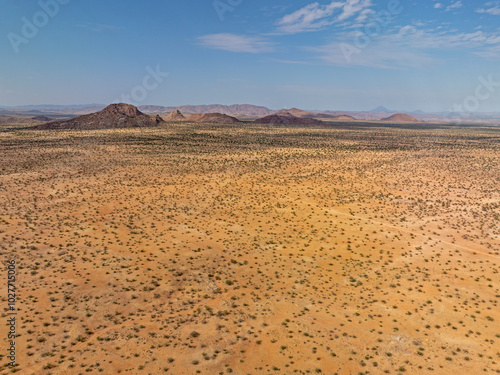 Desert landscape with ed granite hills around the Brandberg Mountain, nearby Uis city, Namibia photo