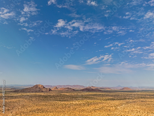 Desert landscape with ed granite hills around the Brandberg Mountain, nearby Uis city, Namibia photo