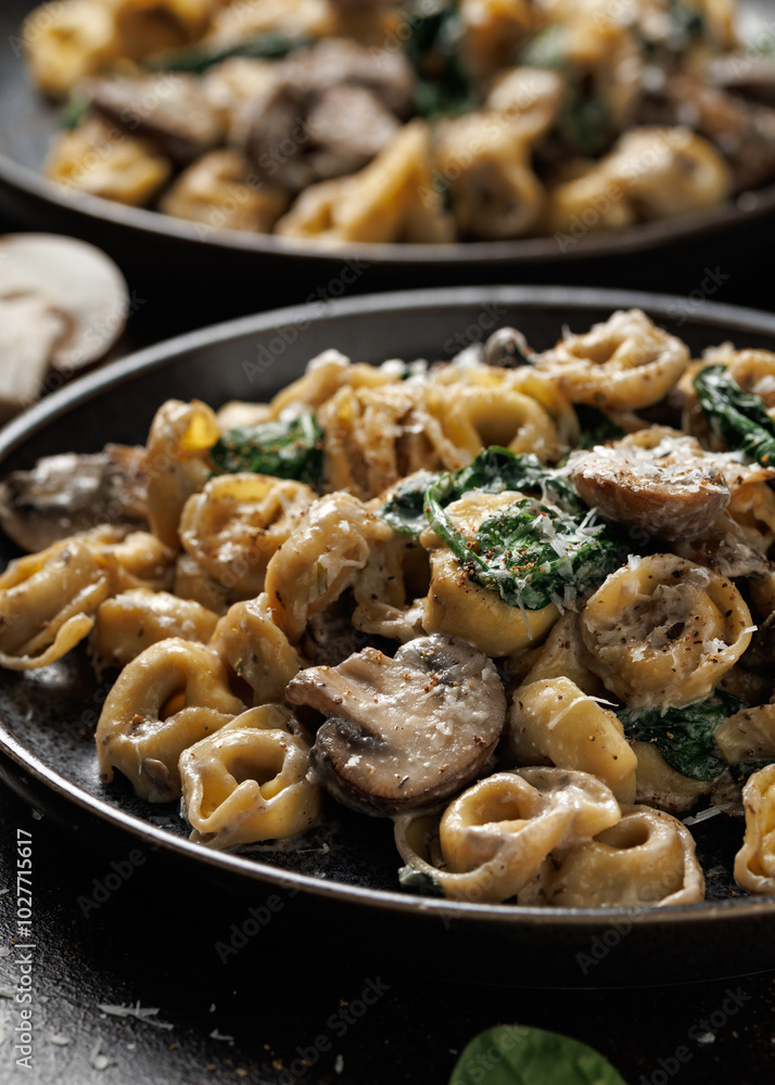 Chestnut Mushrooms and spinach tortellini served with parmesan cheese Chestnut Mushrooms and spinach tortellini served with parmesan cheese