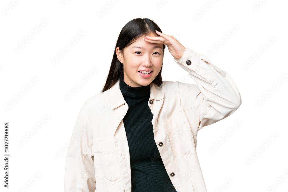 Young Asian woman over isolated chroma key background looking far away with hand to look something Young Asian woman over isolated chroma key background looking far away with hand to look something